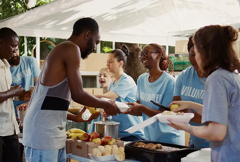 Volunteers serving food to community members.